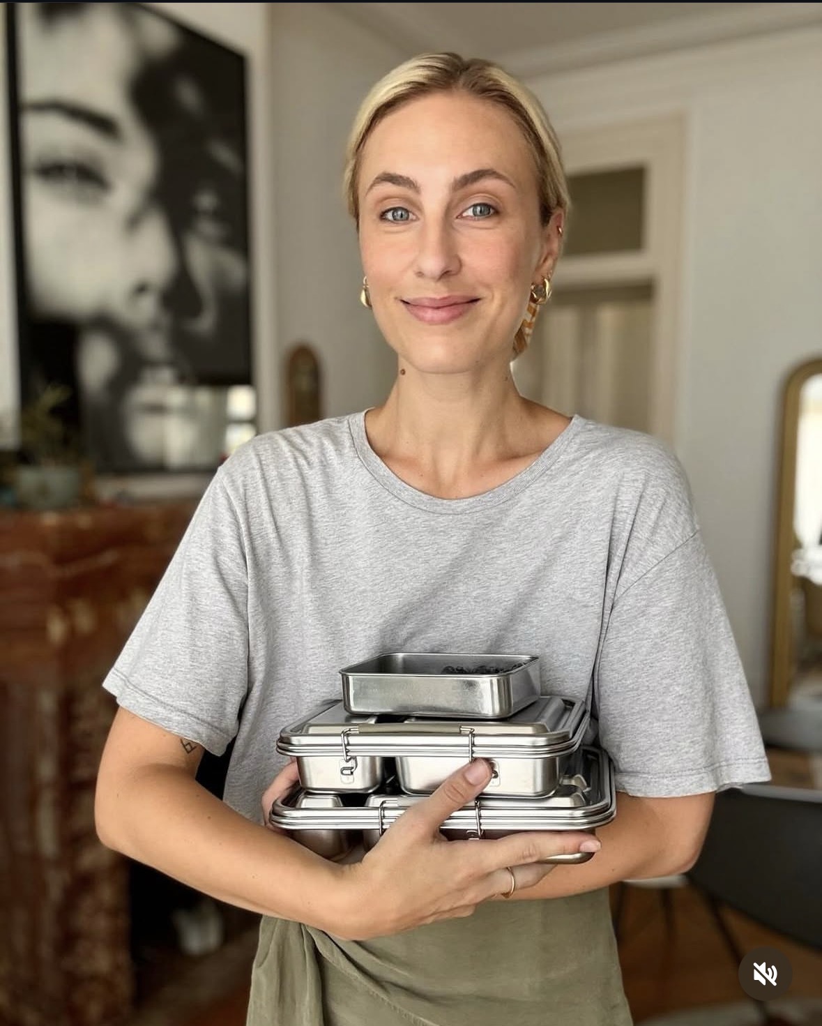 Founder holding a stack of stainless steel lunchboxes